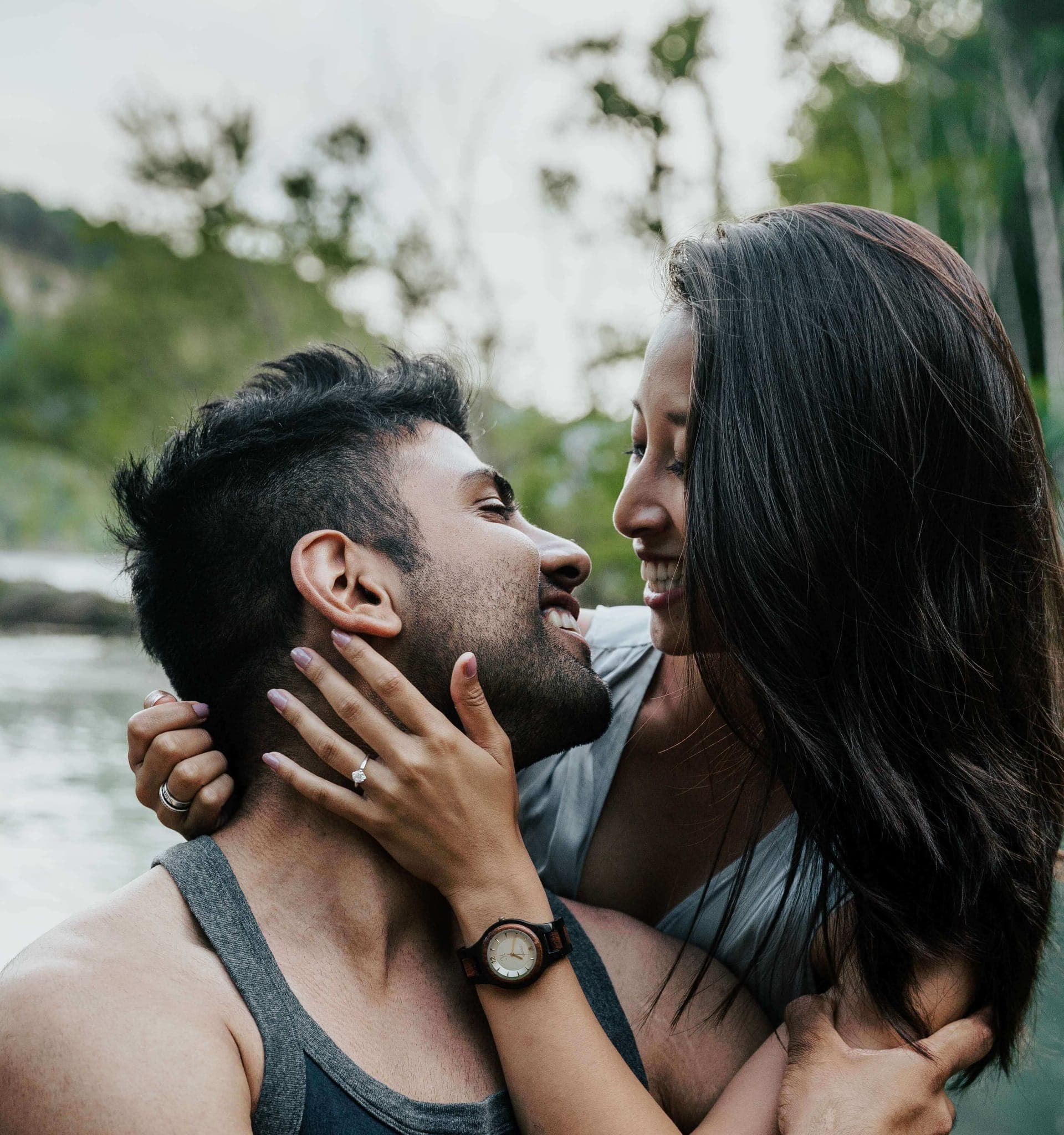 Samantha resting a hand on Amir's cheek, their rings showing
