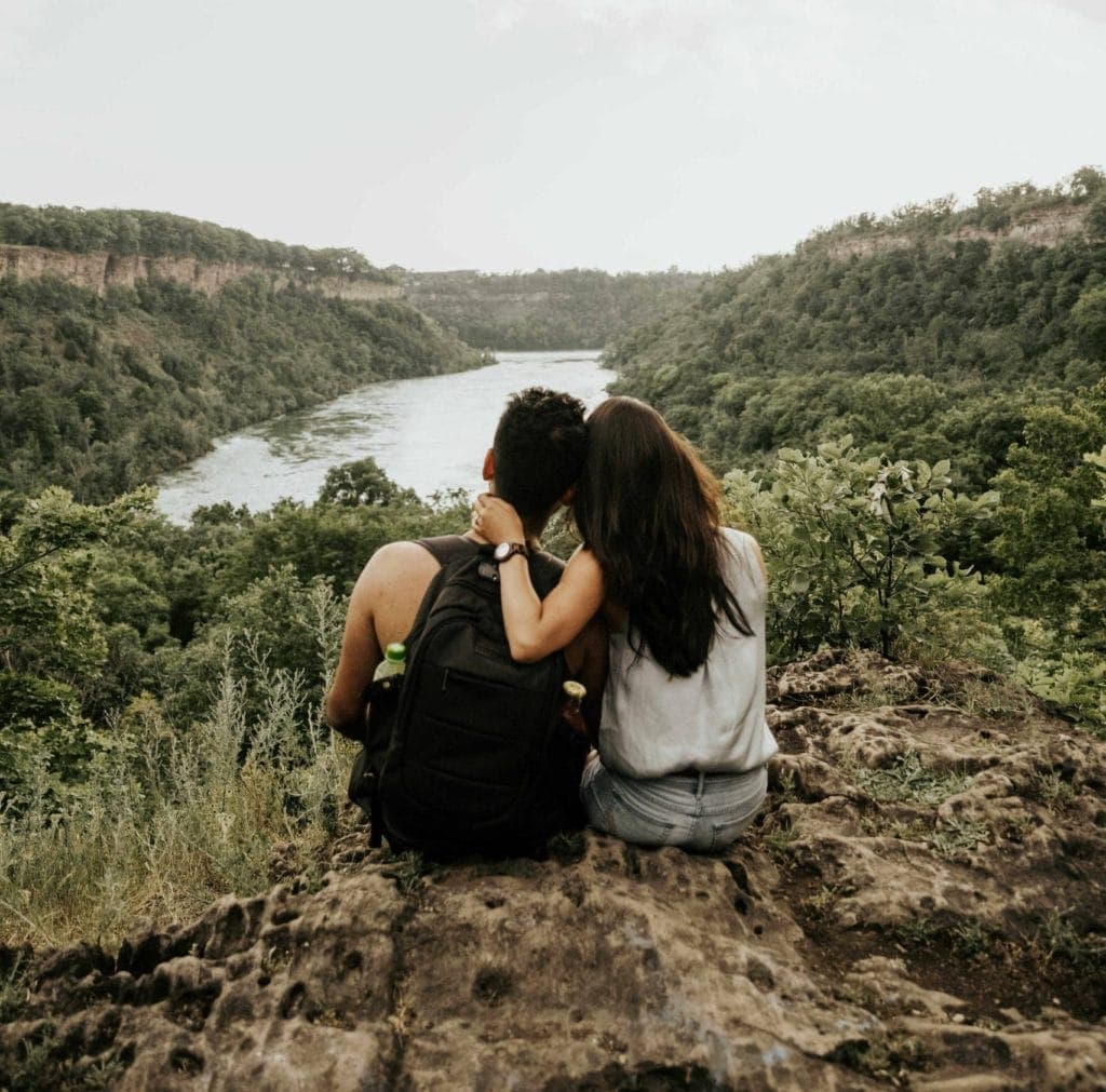 Amir and Samantha sitting on a rock looking out over the gorge